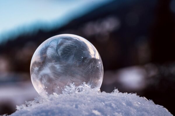 frosty bubble resting on snow in winter